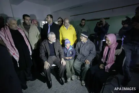 Palestinian Prime Minister in Gaza Strip Ismail Haniyeh, inspects the people who have been evacuated from their houses after flooded with rainwater, in Deir al-Balah in central Gaza Strip December 13, 2013. Haniyeh said...