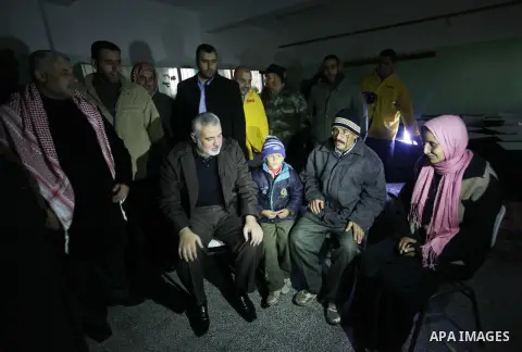 Palestinian Prime Minister in Gaza Strip Ismail Haniyeh, inspects the people who have been evacuated from their houses after flooded with rainwater, in Deir al-Balah in central Gaza Strip December 13, 2013. Haniyeh said...