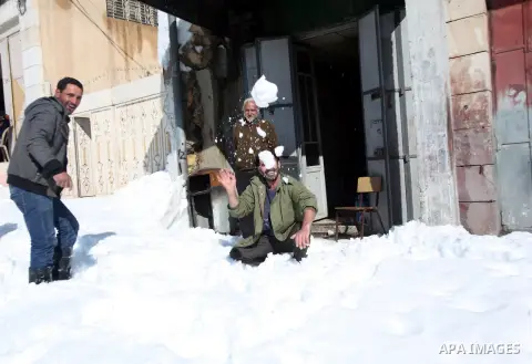 Palestinians play with snow in the West Bank city of Hebron, Sunday, Dec. 15, 2013. The Gaza Strip received its first shipment of industrial fuel in 45 days Sunday. A lack of fuel has hampered rescue efforts in Gaza, whe...