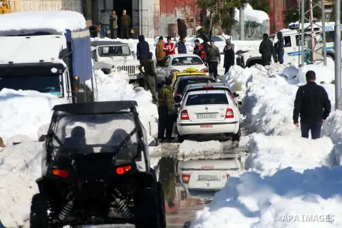 A picture shows cars stuck on a road covered with snow in the West Bank city of Hebron, Sunday, Dec. 15, 2013. The Gaza Strip received its first shipment of industrial fuel in 45 days Sunday. A lack of fuel has hampered...
