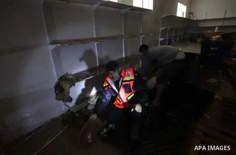 Palestinians try to save medicines at a drugstore after being flooded during four days of storms in Beit Hanoun, in the northern Gaza Strip, December 16, 2013. The results of winter storm Alexa in Gaza will lead to a hea...