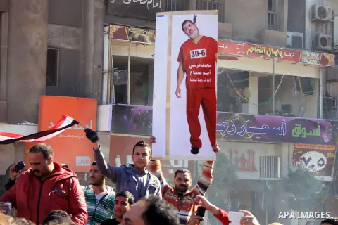 Egyptians react following a powerful car bomb explosion in the Egyptian city of Mansura, North of Cairo on December 24, 2013. The bombing tore through a police building in Mansura early today, killing at least 14 people,...