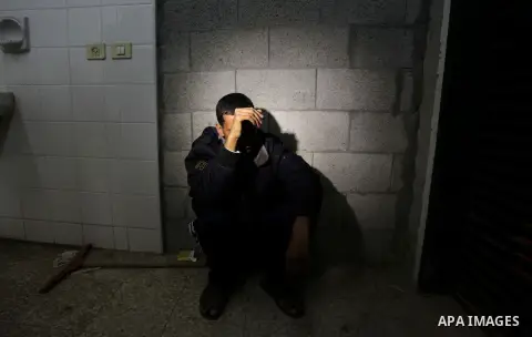 A Palestinian relative weeps after seeing the lifeless body of 3-year-old Hala Abu Sebakha, who medics said was killed by shrapnel during an Israeli air strike on Al Maghazi camp, at the morgue of Al-Aqsa hospital in Dei...