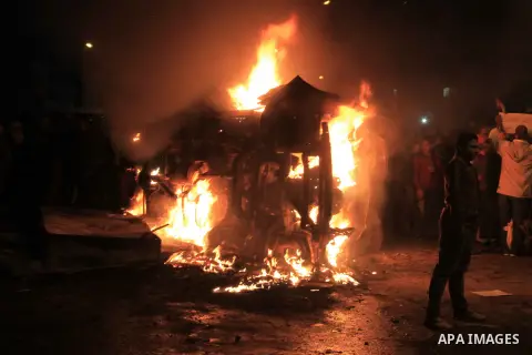 Angry Egyptians set fire to a microbus, said to be belong to a company owned by a businessman who supports the Muslim Brotherhood, after passengers allegedly held up four fingers, the symbol known as "Rabaa", during the...
