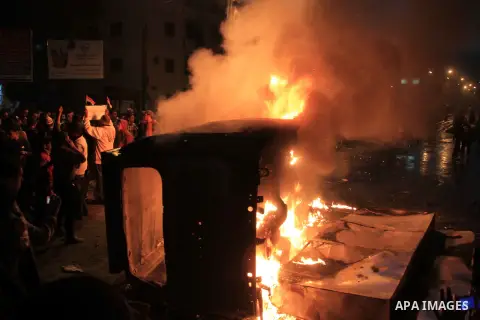 Angry Egyptians set fire to a microbus, said to be belong to a company owned by a businessman who supports the Muslim Brotherhood, after passengers allegedly held up four fingers, the symbol known as "Rabaa", during the...