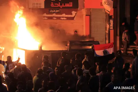 Angry Egyptians set fire to a microbus, said to be belong to a company owned by a businessman who supports the Muslim Brotherhood, after passengers allegedly held up four fingers, the symbol known as "Rabaa", during the...