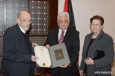 Palestinian President, Mahmoud Abbas (Abu Mazen), gives the mayor of Bethlehem, former Hanna Jamil Nasser, the Order of Merit and Excellence in the West Bank city of Bethlehem, on Dec. 24, 2013. Photo by Thaer Ganaim