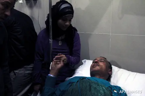 Jamal Saleh, 48, lies on a bed after injured by a bomb blast in Cairo, Egypt, Thursday, Dec. 26, 2013. The bomb blast hit a public bus in the Egyptian capital, wounding several people, the Interior Ministry said, in an a...