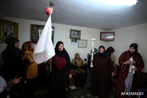Relatives of Palestinian prisoner Bilal Abu Hassin celebrate at his home in the Arab East Jerusalem neighbourhood of Jabal Mukaber December 30, 2013. Israel is due to free about two dozen Palestinian prisoners, including...