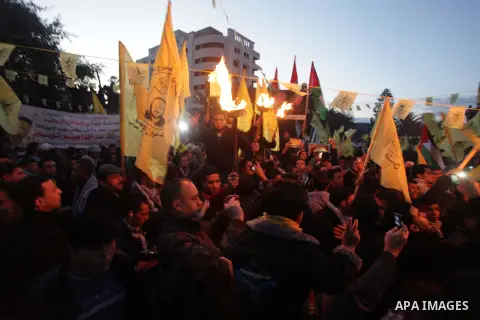Palestinian supporters of Fatah movement hold the party's torch during a rally in Gaza city on December 31, 2013. Tens of thousands of Fatah supporters rallied in Gaza City on Tuesday to celebrate the 49th anniversary of...