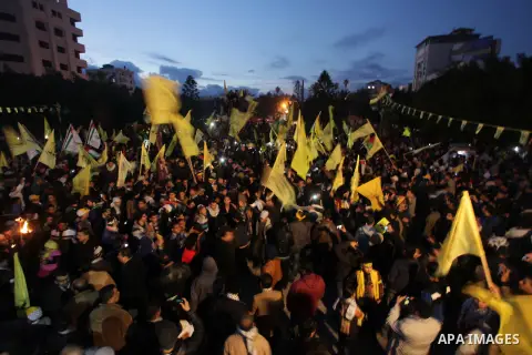 Palestinian supporters of Fatah movement hold the party's torch during a rally in Gaza city on December 31, 2013. Tens of thousands of Fatah supporters rallied in Gaza City on Tuesday to celebrate the 49th anniversary of...