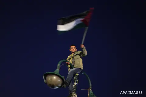 Palestinian supporters of Fatah movement hold the party's torch during a rally in Gaza city on December 31, 2013. Tens of thousands of Fatah supporters rallied in Gaza City on Tuesday to celebrate the 49th anniversary of...