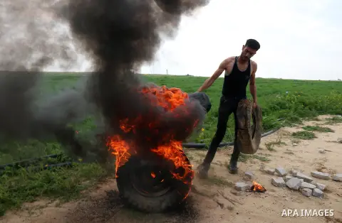 Palestinian protesters burn tires at the Israel-Gaza border east of Khan Yunis in the southern Gaza Strip, on February 23, 2020. Israeli troops opened gunfire at Palestinian civilians and injured two of them, as they wer...