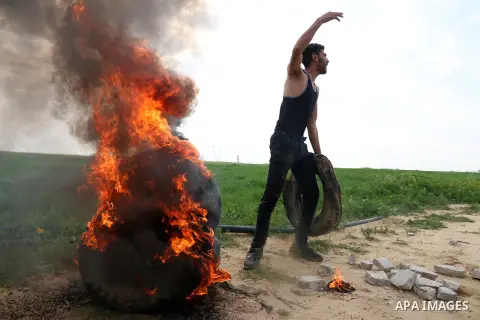 Palestinian protesters burn tires at the Israel-Gaza border east of Khan Yunis in the southern Gaza Strip, on February 23, 2020. Israeli troops opened gunfire at Palestinian civilians and injured two of them, as they wer...