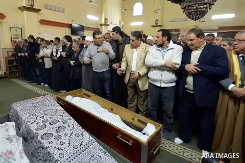 Egyptian mourners pray over the coffin of Mamdouh el-Leithi during his funeral in Cairo on January 1, 2014. Prominent producer and scenarist Mamdouh el-Leithi passed away on Wednesday morning at the age of 77. Photo by M...