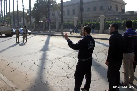 Students of Cairo University, who are supporters of the Muslim Brotherhood and deposed Egyptian President Mohamed Mursi, rise four fingers which has become a symbol of the Rabaah al-Adawiya mosque in front of security fo...