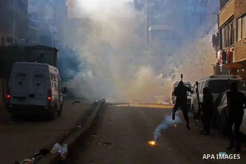 Egyptian security forces clash with supporters of ousted President Mohamed Morsi in the El-Omraneya neighborhood in Cairo, Egypt, Friday Jan. 10, 2014. Hundreds of Islamists rallied in Egypt s capital and across the coun...
