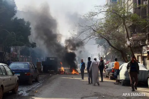 Egyptian security forces clash with supporters of ousted President Mohamed Morsi in the El-Omraneya neighborhood in Cairo, Egypt, Friday Jan. 10, 2014. Hundreds of Islamists rallied in Egypt s capital and across the coun...