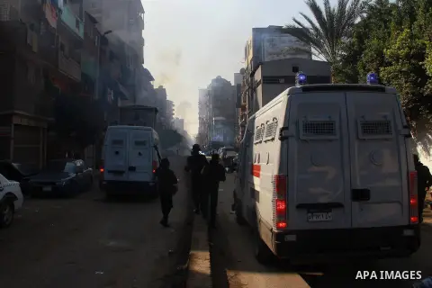 Egyptian security forces clash with supporters of ousted President Mohamed Morsi in the El-Omraneya neighborhood in Cairo, Egypt, Friday Jan. 10, 2014. Hundreds of Islamists rallied in Egypt s capital and across the coun...