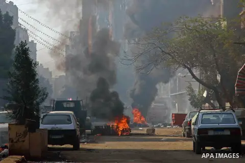 Egyptian security forces clash with supporters of ousted President Mohamed Morsi in the El-Omraneya neighborhood in Cairo, Egypt, Friday Jan. 10, 2014. Hundreds of Islamists rallied in Egypt s capital and across the coun...