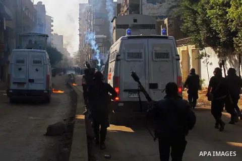 Egyptian security forces clash with supporters of ousted President Mohamed Morsi in the El-Omraneya neighborhood in Cairo, Egypt, Friday Jan. 10, 2014. Hundreds of Islamists rallied in Egypt s capital and across the coun...
