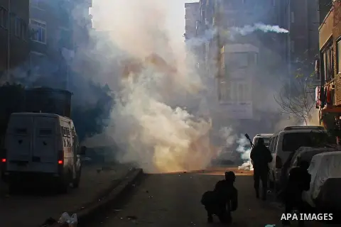 Egyptian security forces clash with supporters of ousted President Mohamed Morsi in the El-Omraneya neighborhood in Cairo, Egypt, Friday Jan. 10, 2014. Hundreds of Islamists rallied in Egypt s capital and across the coun...
