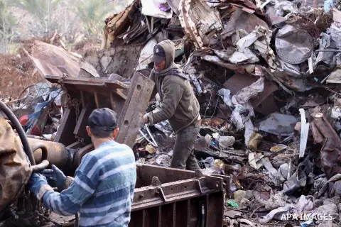 Palestinian labourers work at workshop for scrap iron compress in Gaza city, on Jan.11, 2014. Israeli authorities stopped importing scraped iron from Gaza strip since 2006 led to pile up over 100.000 tonnes of used iron...