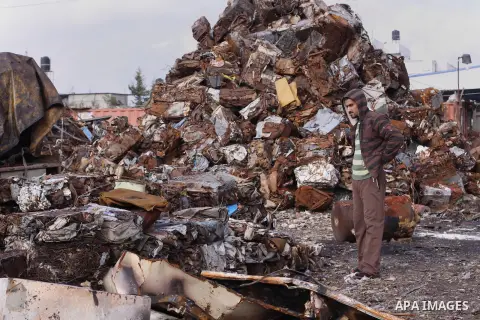 Palestinian labourers work at workshop for scrap iron compress in Gaza city, on Jan.11, 2014. Israeli authorities stopped importing scraped iron from Gaza strip since 2006 led to pile up over 100.000 tonnes of used iron...