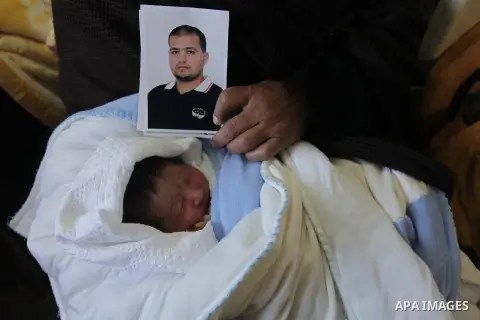 Palestinian mother Hanaa al-Zanen, 26, holds her new born baby boy, who was conceived with sperm from her husband smuggled out of an Israeli prison, at a hospital in Gaza City on January 11, 2013. The boy is the son of P...