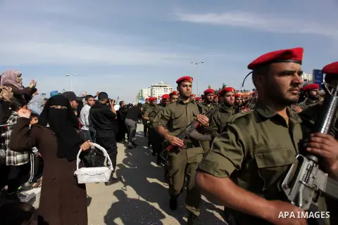 Palestinian security forces show their skills during a military parade in Gaza city on January 13, 2014, marking the fifth anniversary of the three-week Israeli offensive on the Gaza Strip in which more than a thousand P...