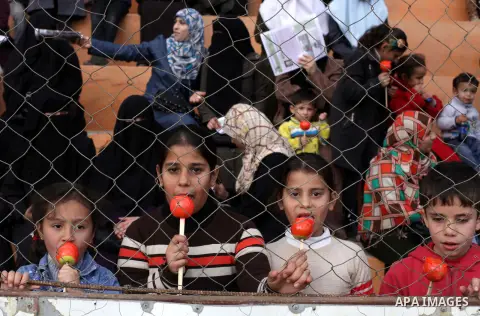 Palestinians attend a graduation ceremony for a military-style training programme in Gaza City on January 14, 2014. Some 13,000 students joined the course, which is aimed at preparing them for "liberating Palestine from...