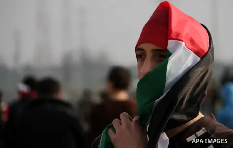 Palestinian protesters take part in a demonstration near the Nahal Oz border crossing with Israel, east of Gaza City on January 17, 2014. The Israeli army fired live rounds and tear gas at protesters near the border fenc...