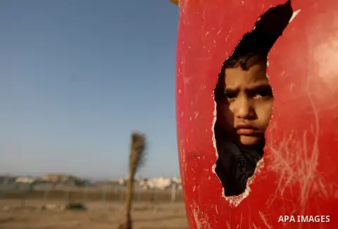 Palestinian children play outside their house in Al Sultan refugee camp in Rafah, southern of Gaza Strip on, 18 Jan, 2014. Photo by Eyad Al Baba