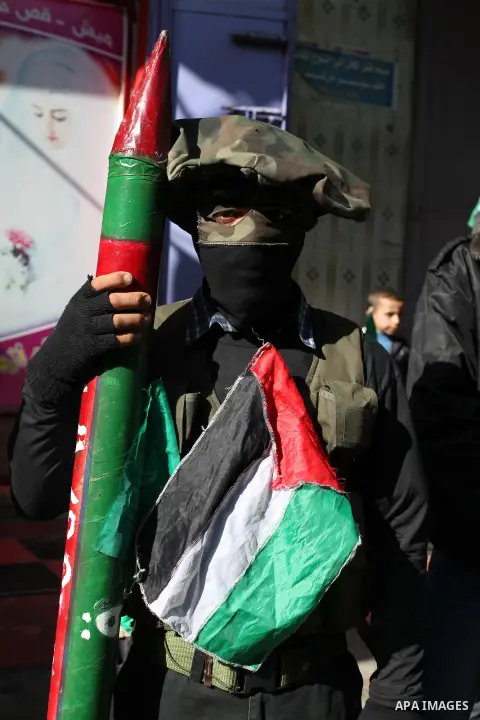 Palestinian supporters of Hamas movement take part in a demonstration in solidarity with Palestinian refugees in the Yarmouk refugee camp in the suburbs of the Syrian capital of Damascus, in Nuseirat camp in central Gaza...