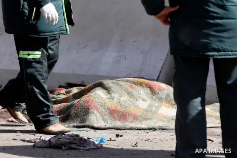 Egyptian security forces stand next to a body of a died man at the site of a car bomb explosion outside the police headquarters in Cairo on January 24, 2014. A suicide bomber struck Cairo police headquarters in the first...