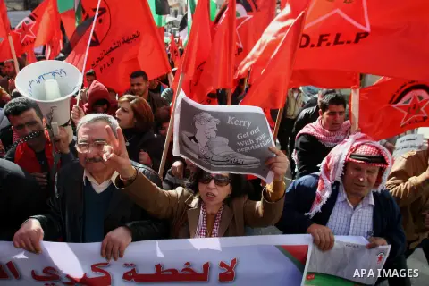 Palestinian protesters take part a demonstration against visit the US Secretary of State John Kerry, in the West Bank city of Nablus. Jan. 25, 2014. Kerry called for mutual recognition of "the Jewish state of Israel and...