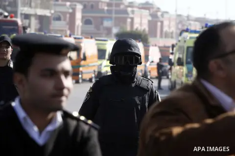 Police and security forces stand guard outside a police academy, where the trial of ousted Egyptian President Mohamed Mursi and members of the Muslim Brotherhood is due to take place, on the outskirts of Cairo, January 2...