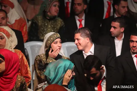 Palestinian couples are pictured on January 28, 2014, during a mass wedding ceremony attended by Palestinian Authority President Mahmud Abbas (unseen) in the West bank city of Jericho. Nearly 300 Palestinians were marrie...