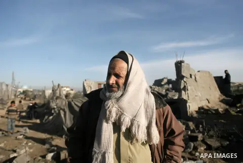 An elderly Palestinian man inspects the rubble of his home following an Israeli air strike that injured two Palestinians, in the southern Gaza Strip town of Rafah on January 31, 2014. Photo by Eyad Al Baba