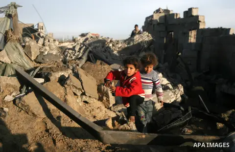Palestinian children inspect the damage done to a house following an Israeli air strike that injured two Palestinians, in the southern Gaza Strip town of Rafah on January 31, 2014. Photo by Eyad Al Baba