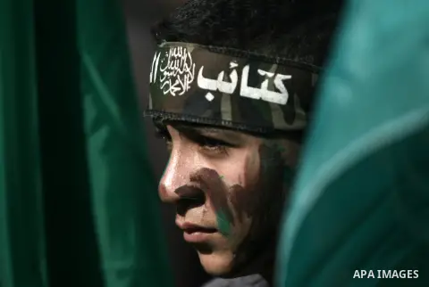 Palestinian supporters of Hamas movement take part in a demonstration in solidarity with refugees in Yarmouk refugee camp in Syria, in Khan Younis in the southern Gaza Strip January 31, 2014. Photo by Eyad Al Baba