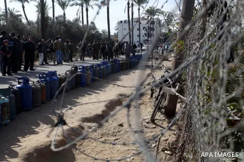 Palestinians wait in line to refill cooking gas bottles at a warehouse in Deir al-Balah center Gaza Strip on Feb. 01, 2014. Photo by Ashraf Amra