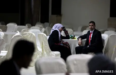 Palestinian couples take part in a mass wedding ceremony in Gaza City on February 04, 2014. Nearly 50 Palestinians were married in the Gaza Strip in a mass wedding funded by the office of Palestinian President Mahmoud Ab...