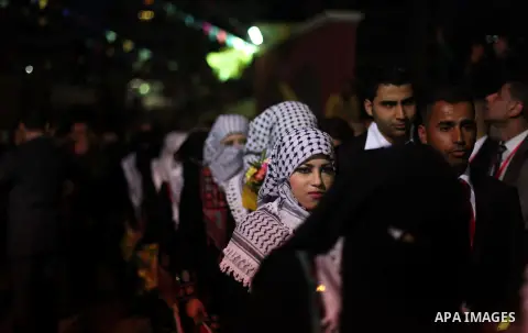 Palestinian couples take part in a mass wedding ceremony in Gaza City on February 04, 2014. Nearly 50 Palestinians were married in the Gaza Strip in a mass wedding funded by the office of Palestinian President Mahmoud Ab...