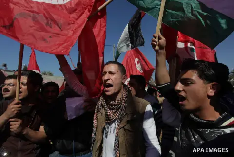 Supporters of Palestinian People's Party wave their national flag during a moot court against of the war criminals Prime Minister of Israel Benjamin Netanyahu, and former Prime Minister Ehud Barak in front of the headqua...