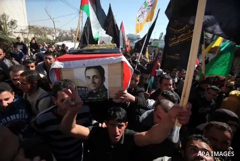 Palestinians carry a coffin containing the remains of Ahmed al-Faqih, during a funeral in the West Bank village of Dura, southeast of Hebron, Feb. 10, 2014. Israel on Sunday evening delivered the remains of Ahmad Ayid Fa...