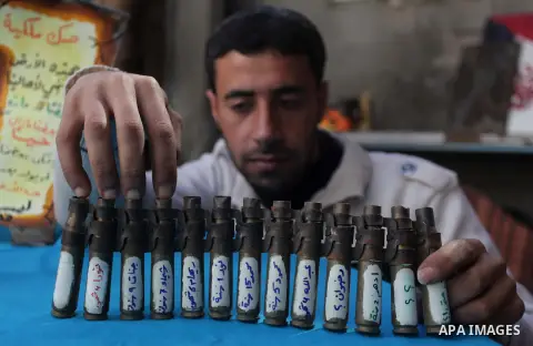 Palestinian Mohammed al-Zomar, 32, displays the remains of Israeli ammunition at his studio in the central Gaza Strip February 12, 2014. Al-Zomar draws and paints on remains of Israeli ammunition that he collected during...