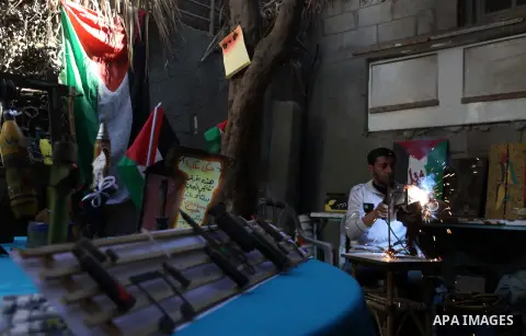 Palestinian Mohammed al-Zomar, 32 works on the remains of Israeli ammunition at his studio in the central Gaza Strip February 12, 2014. Al-Zomar draws and paints on remains of Israeli ammunition that he collected during...