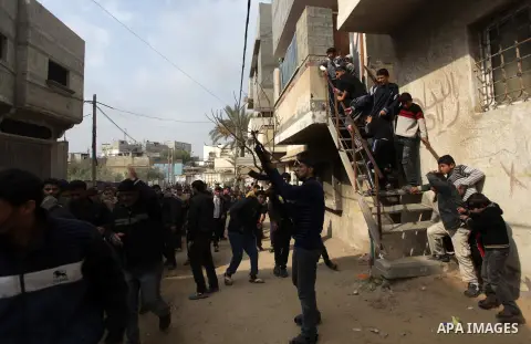 A Palestinian militant fires into air during the funeral of Ibrahim Mansour, 26, who was killed by Israeli soldiers, in Gaza City February 14, 2014. Israeli soldiers shot and killed Mansour and wounded another on Thursda...