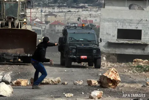 Palestinian protesters clash with Israeli security forces following a demonstration against the expropriation of Palestinian land by Israel in the village of Kfar Qaddum, near the occupied West Bank city of Nablus, on Fe...